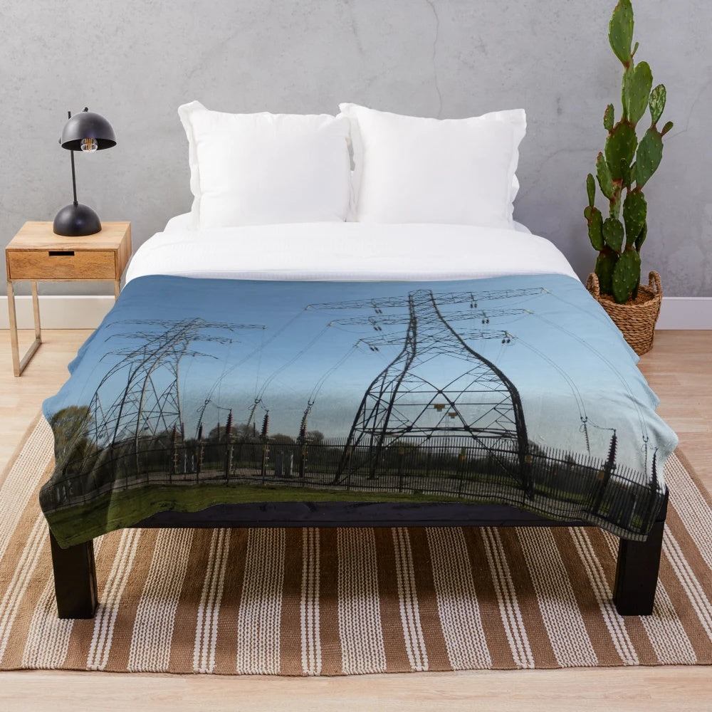 Plush blanket featuring silhouettes of electricity pylons against a countryside landscape