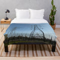 Plush blanket featuring silhouettes of electricity pylons against a countryside landscape
