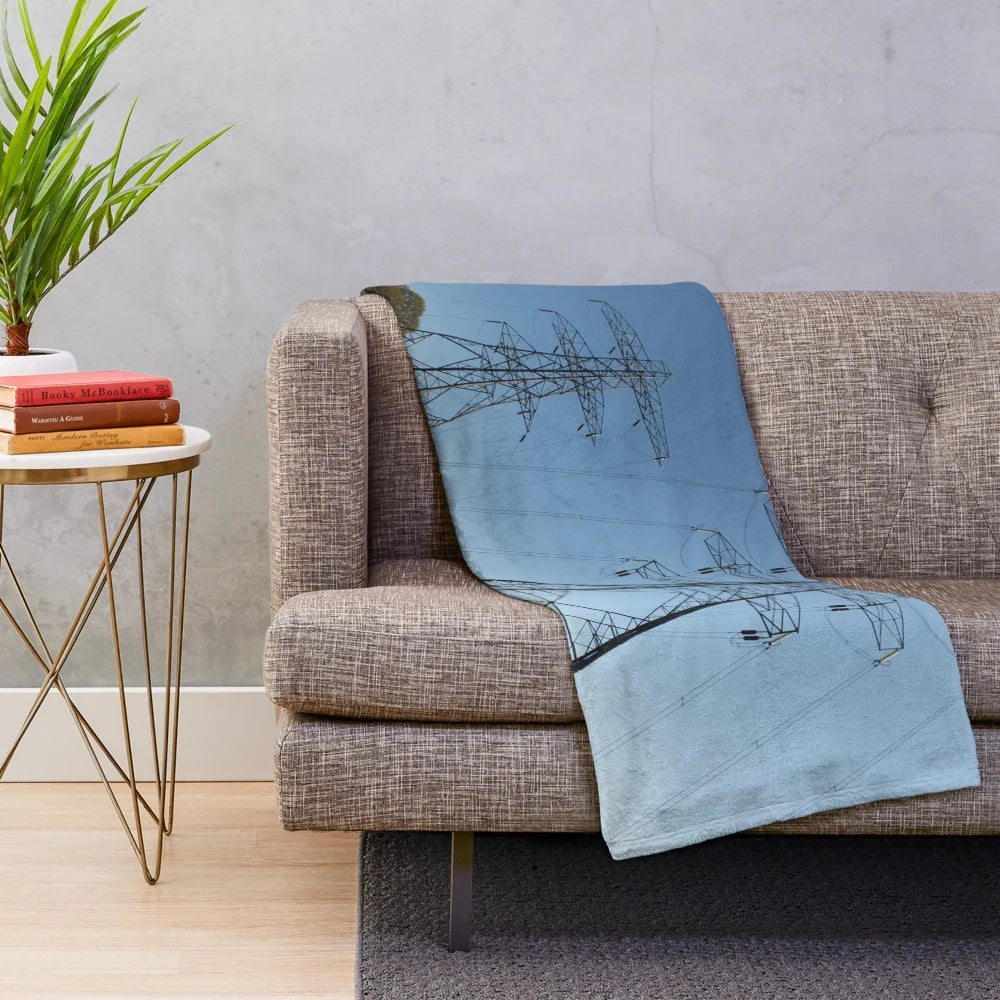 Plush blanket featuring silhouettes of electricity pylons against a countryside landscape