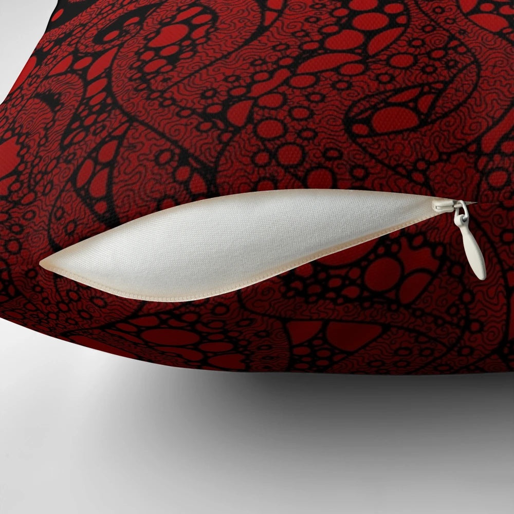 A Pillow featuring a striking red tentacle design against a black background, evoking the mysterious depths of the ocean.