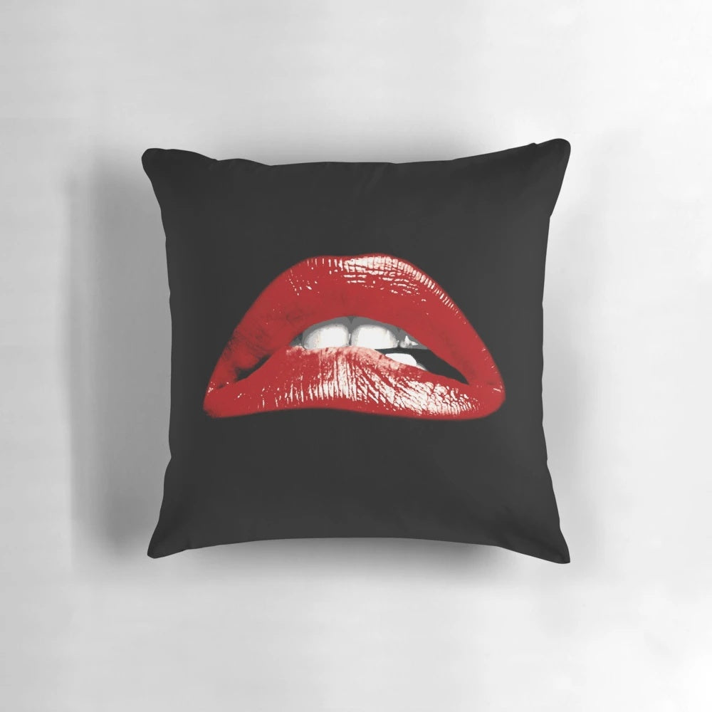 Decorative pillow featuring a vivid graphic of bold, biting lips inspired by the cult classic Rocky Horror Picture Show.