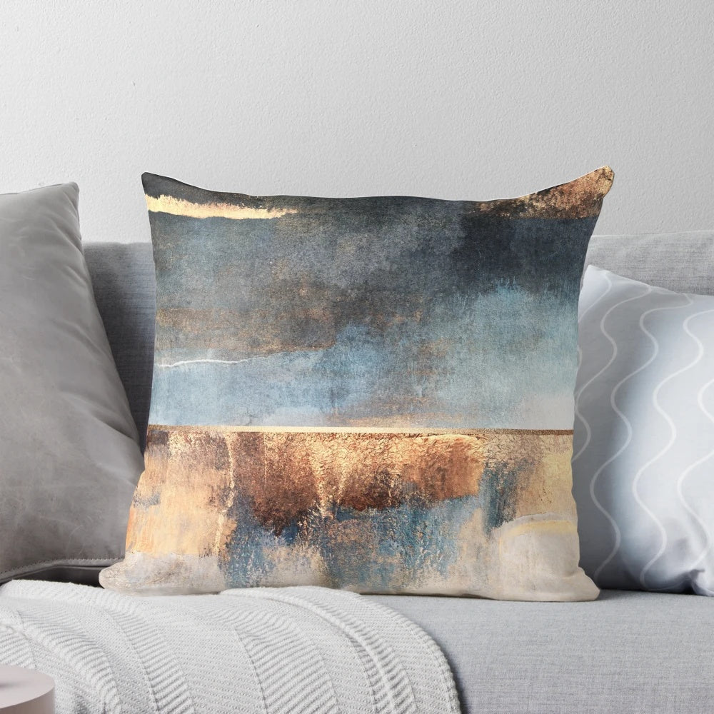 Stunning abstract art pillow with golden accents and a modern, storm-like design