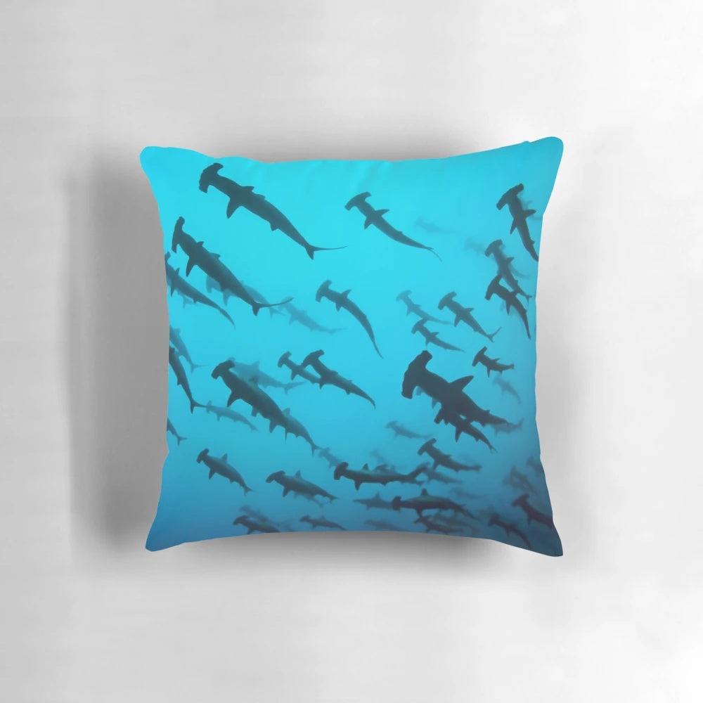 Pillow with a striking silhouette of a scalloped hammerhead shark swimming underwater