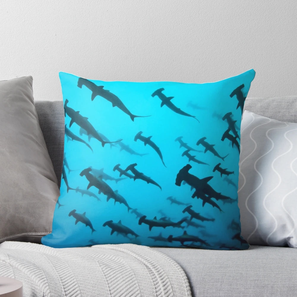 Pillow with a striking silhouette of a scalloped hammerhead shark swimming underwater
