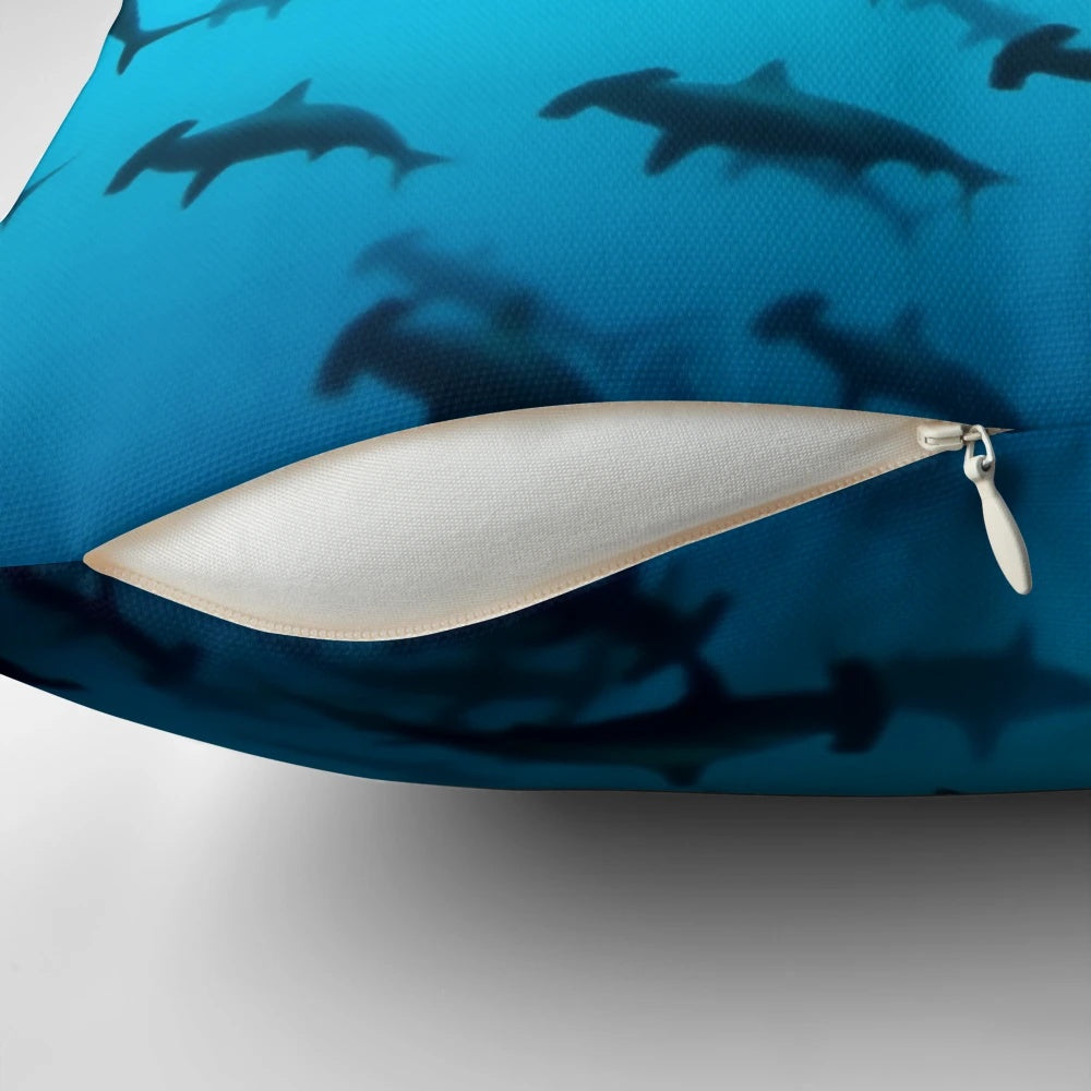 Pillow with a striking silhouette of a scalloped hammerhead shark swimming underwater