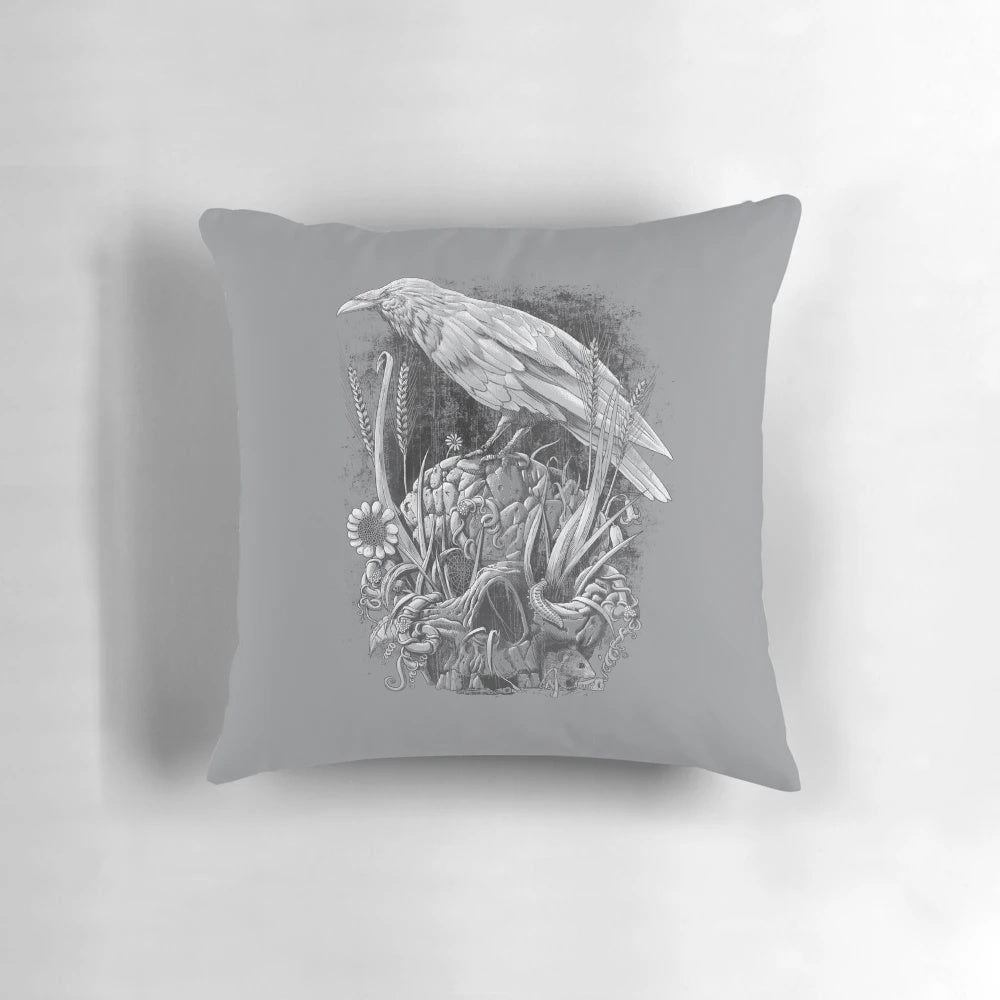 A striking monochrome pillow featuring a detailed raven design with nature elements like flowers, leaves, and vines.