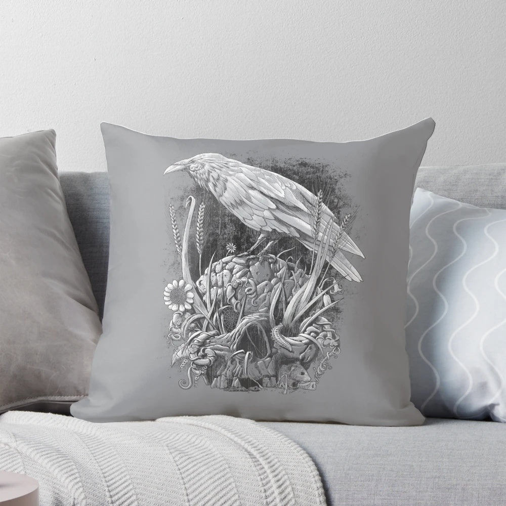 A striking monochrome pillow featuring a detailed raven design with nature elements like flowers, leaves, and vines.