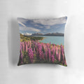 Postcard Pillow featuring a scenic landscape of Lake Pukaki in New Zealand with vibrant lupins in the foreground