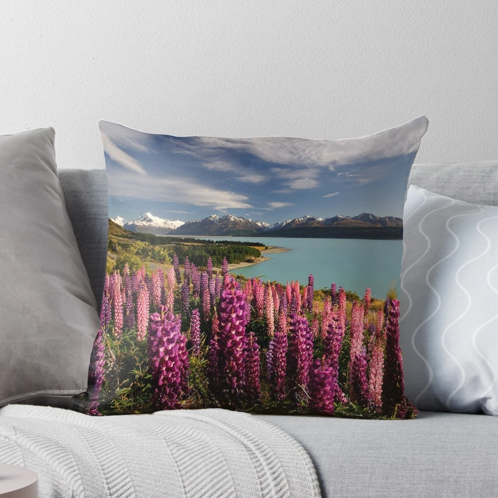 Postcard Pillow featuring a scenic landscape of Lake Pukaki in New Zealand with vibrant lupins in the foreground