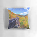 A Pillow showcasing the Frankenstein Trestle in Crawford Notch, New Hampshire, surrounded by vibrant fall foliage in the White Mountains.