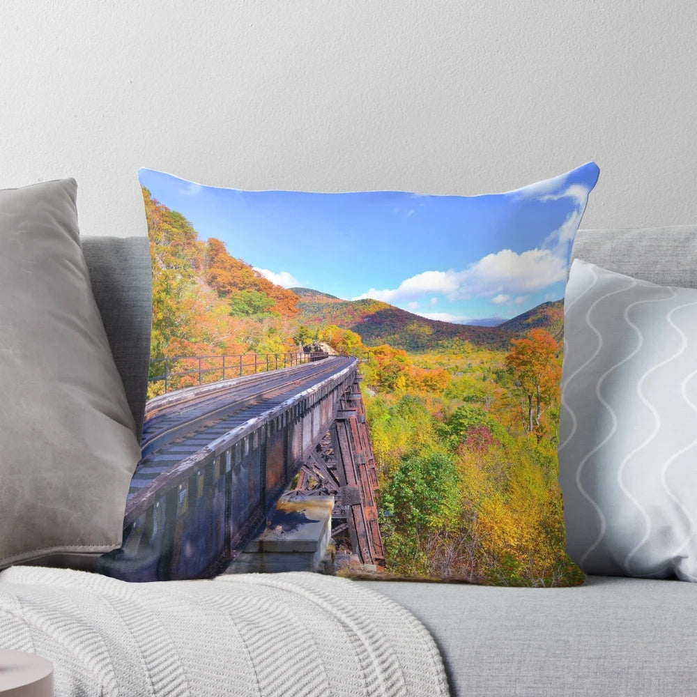 A Pillow showcasing the Frankenstein Trestle in Crawford Notch, New Hampshire, surrounded by vibrant fall foliage in the White Mountains.