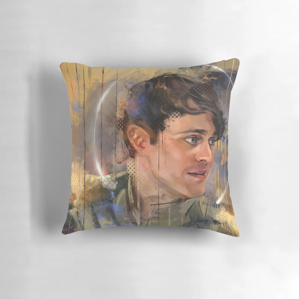 A cozy, decorative pillow featuring a portrait of Joey Batey as The Bard