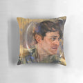 A cozy, decorative pillow featuring a portrait of Joey Batey as The Bard