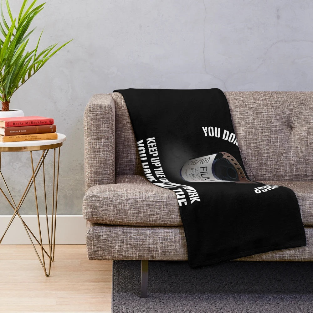 Photography-themed plush blanket with camera and lens design