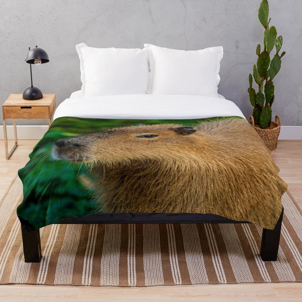 Cozy plush blanket featuring a capybara design, a semi-aquatic herbivore from South America