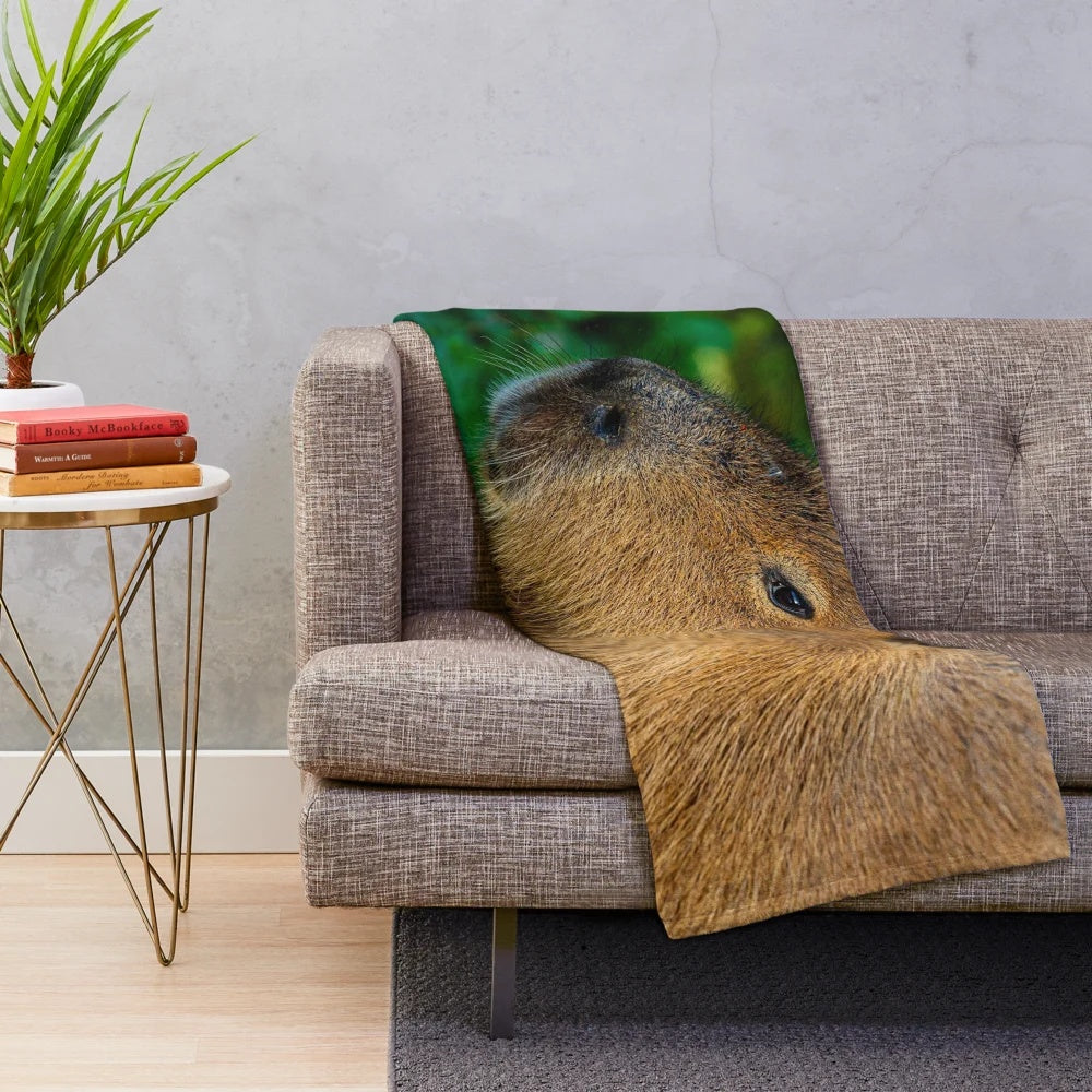 Cozy plush blanket featuring a capybara design, a semi-aquatic herbivore from South America