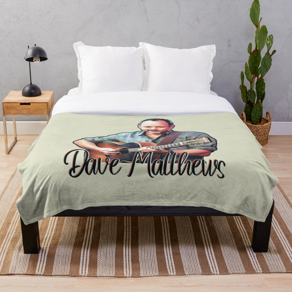 Cartoon illustration of Dave Matthews playing guitar on a plush blanket