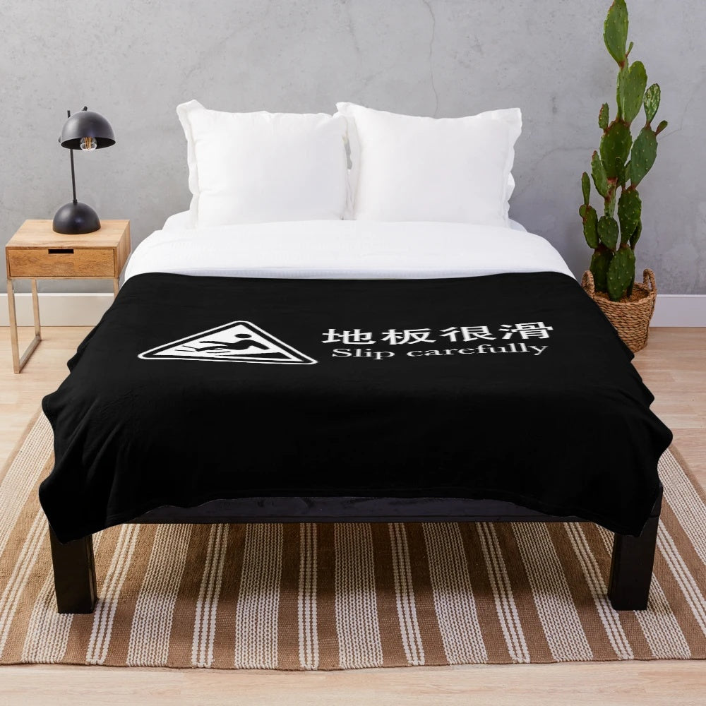 Plush blanket with safety warning message in foreign language