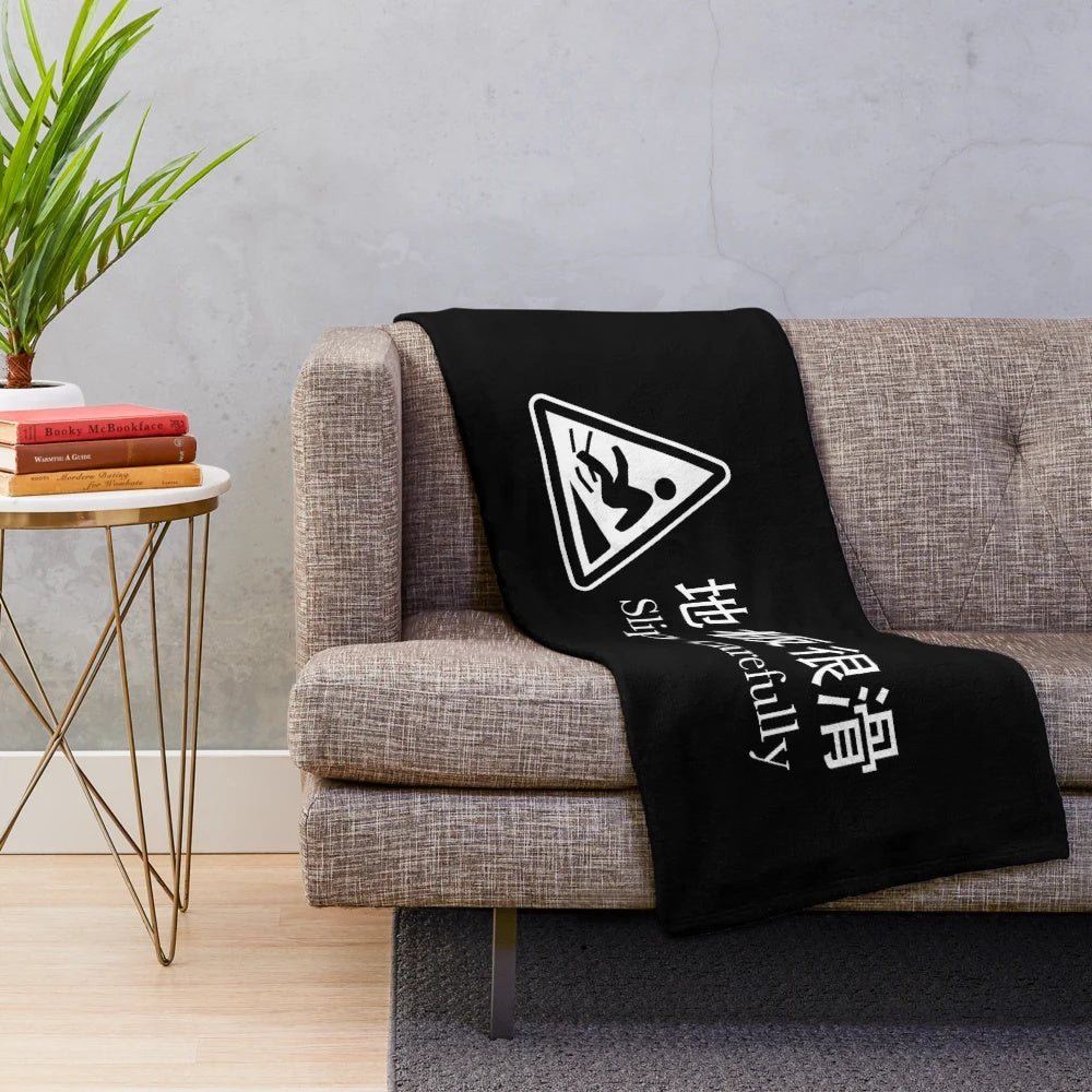 Plush blanket with safety warning message in foreign language