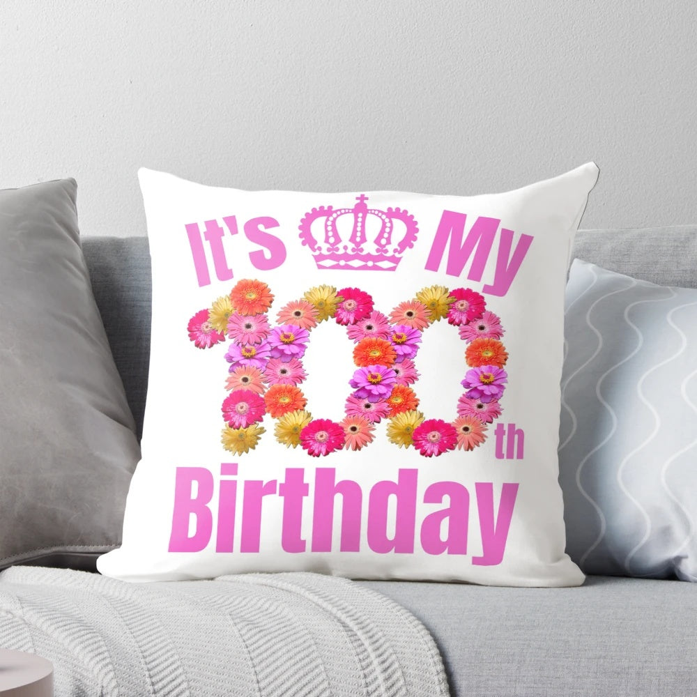 A cozy sweatshirt-style pillow celebrating a 100th birthday with a floral design