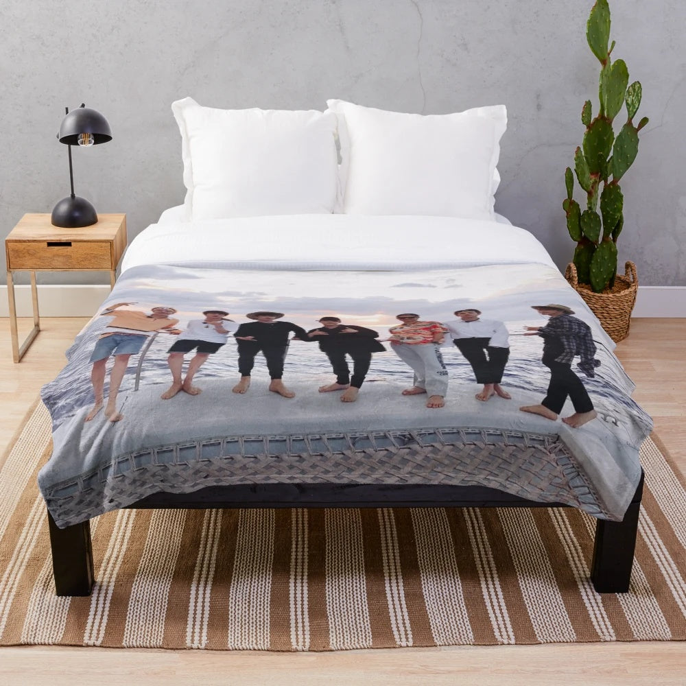 BTS group picture in Hawaii, with members Kim Namjoon, Kim Seokjin, Min Yoongi, Jung Hoseok, Park Jimin, Kim Taehyung, and Jeon Jungkook, printed on a plush blanket