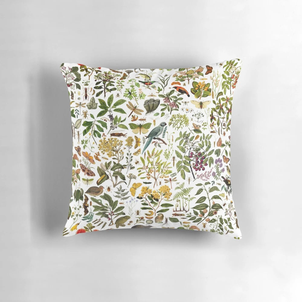 New Zealand-inspired biology pillow featuring a collage of nature elements like butterflies, birds, and flowers.