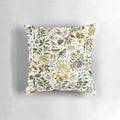 New Zealand-inspired biology pillow featuring a collage of nature elements like butterflies, birds, and flowers.