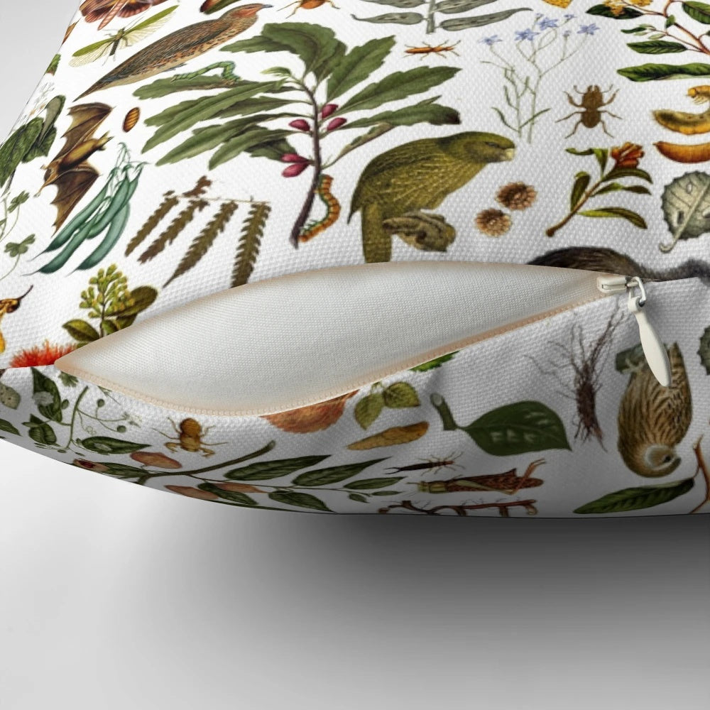 New Zealand-inspired biology pillow featuring a collage of nature elements like butterflies, birds, and flowers.