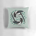 A black and white pillow featuring a minimalist design of a bird, perfect for spring home decor.
