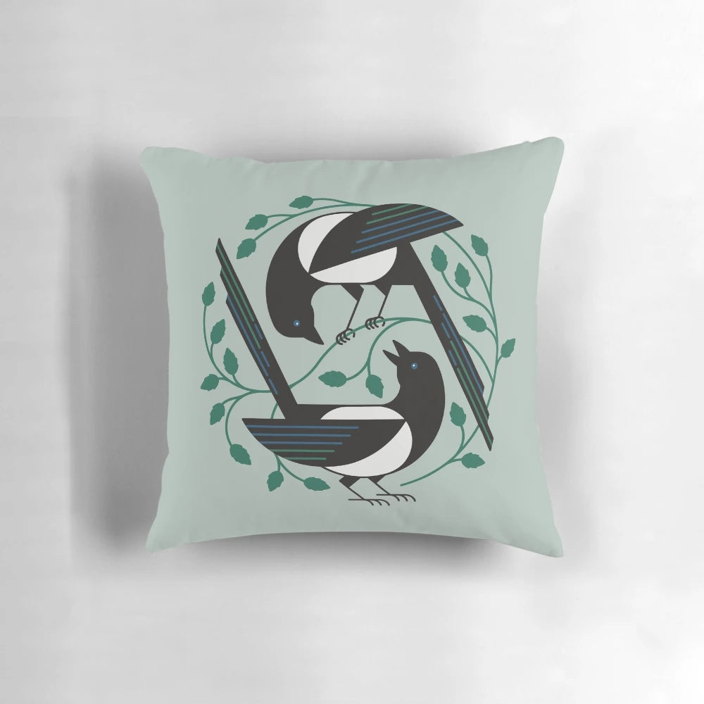 A black and white pillow featuring a minimalist design of a bird, perfect for spring home decor.
