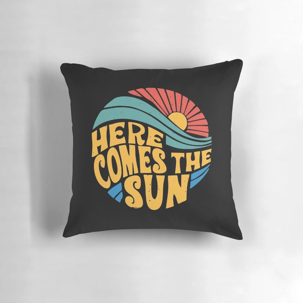 A vibrant and colorful pillow featuring the iconic "Here Comes the Sun" design from the Beatles.