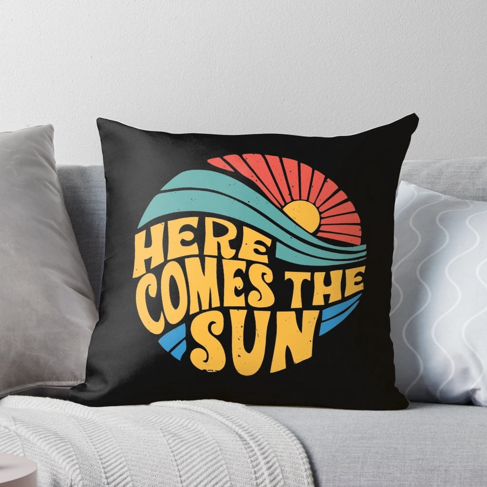 A vibrant and colorful pillow featuring the iconic "Here Comes the Sun" design from the Beatles.