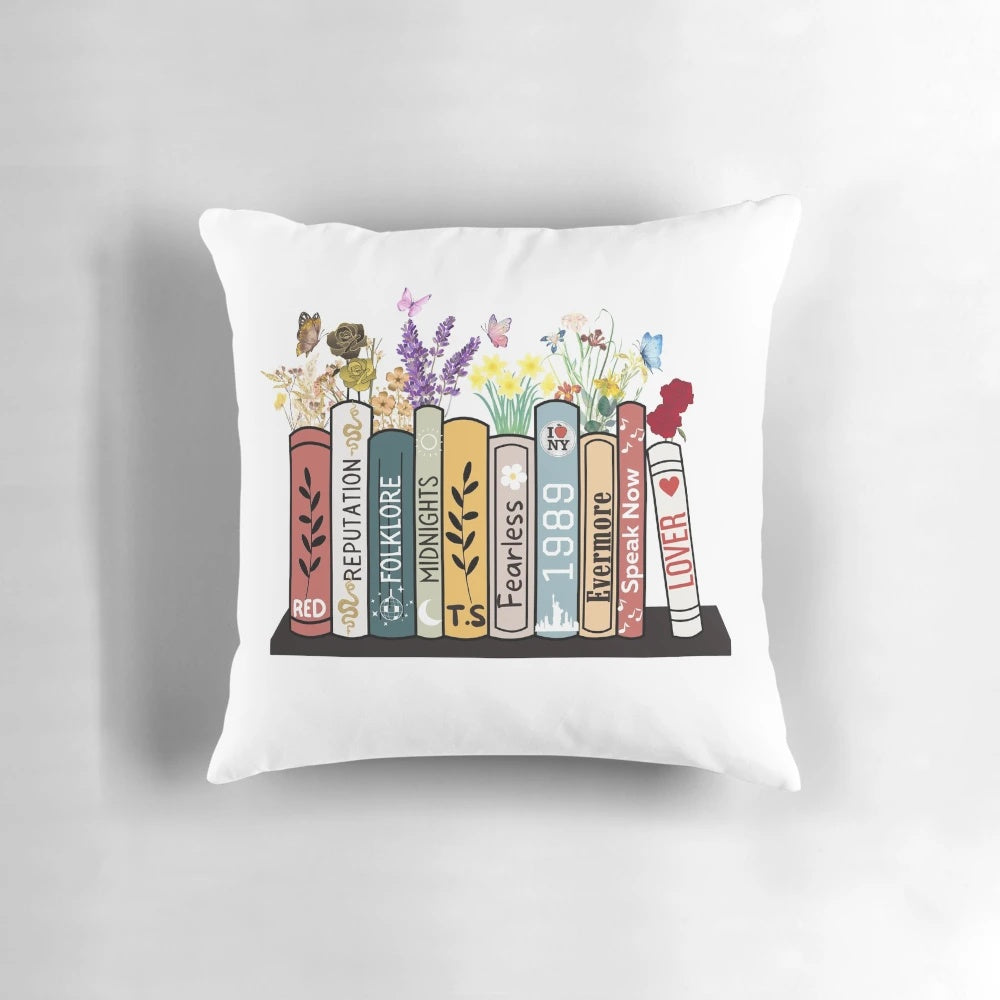 Pillow featuring Taylor Swift's album covers as book spines and flowers, perfect for country music fans
