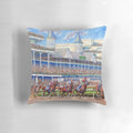 A colorful pillow featuring a painting of horses and jockeys racing at the iconic Churchill Downs racetrack.