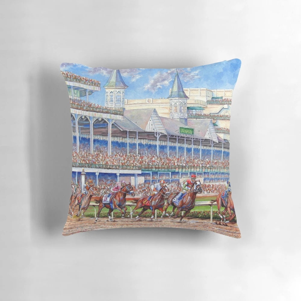 A colorful pillow featuring a painting of horses and jockeys racing at the iconic Churchill Downs racetrack.
