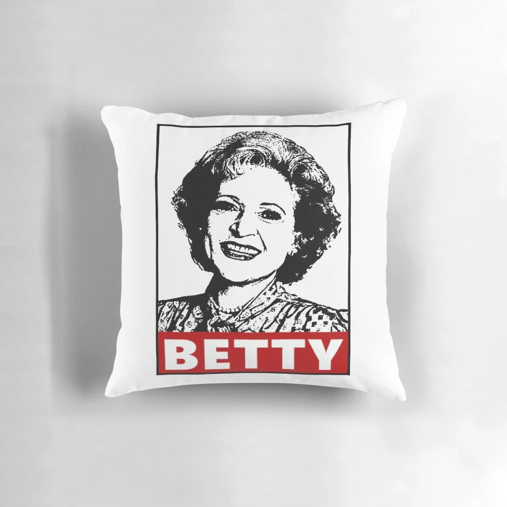 A decorative pillow featuring a portrait of actress Betty White, known for her iconic role in the classic TV series "Golden Girls