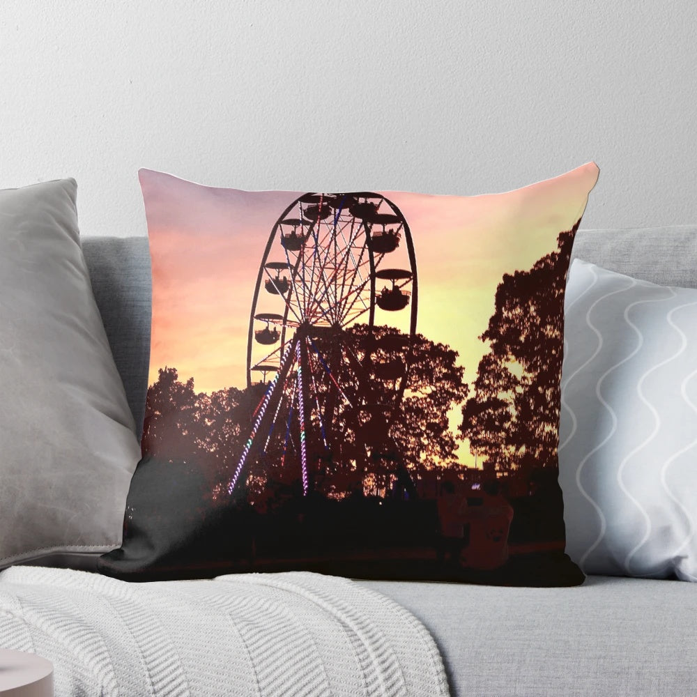 Bonnaroo at Sunset Pillow, featuring a vibrant sunset backdrop with a Ferris wheel and people dancing