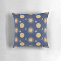 Celestial bodies pillow featuring a navy blue and gold pattern with moons, stars, and constellations