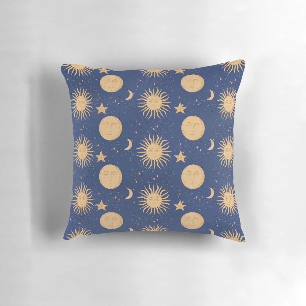 Celestial bodies pillow featuring a navy blue and gold pattern with moons, stars, and constellations