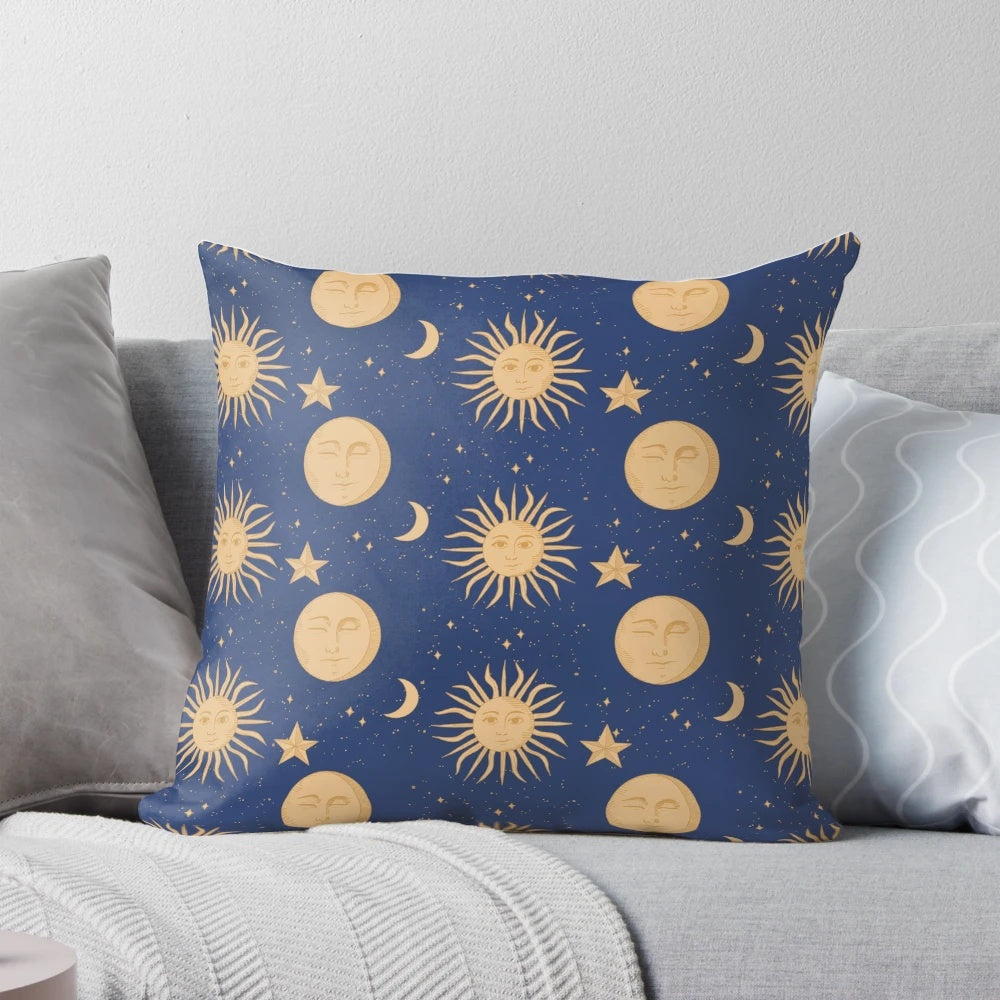 Celestial bodies pillow featuring a navy blue and gold pattern with moons, stars, and constellations