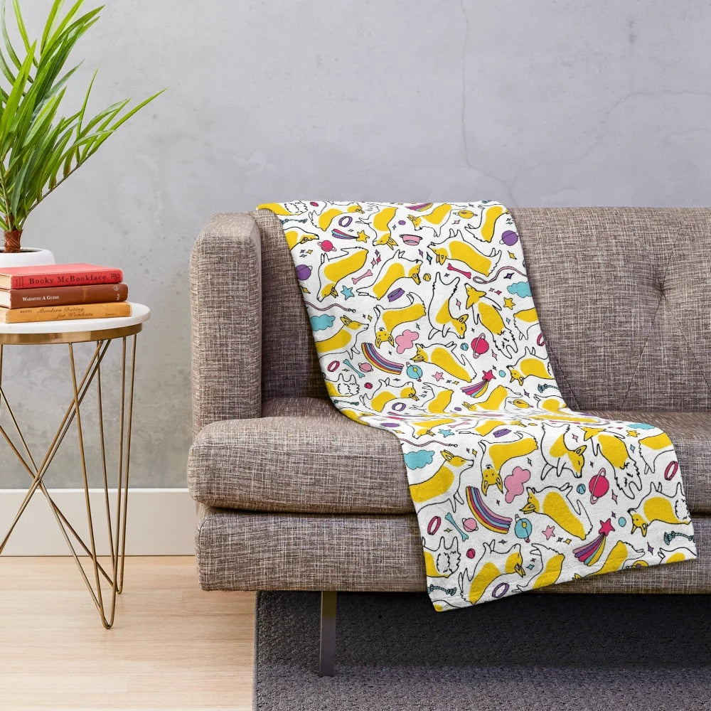Plush blanket featuring a space rainbow motif with adorable cartoon corgis