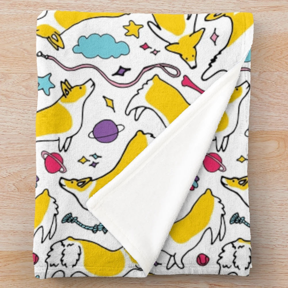 Plush blanket featuring a space rainbow motif with adorable cartoon corgis