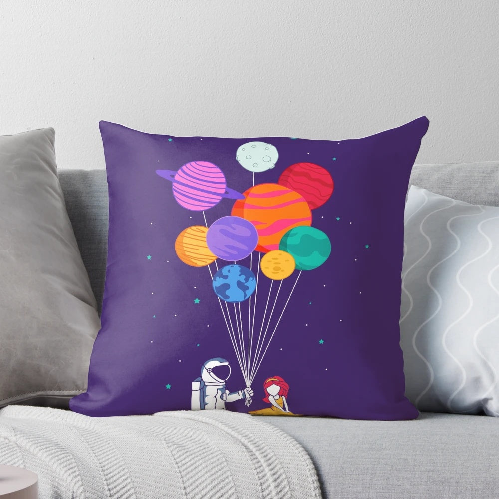A vibrant and colorful pillow depicting a couple floating in space, surrounded by planets, stars, and galaxies.