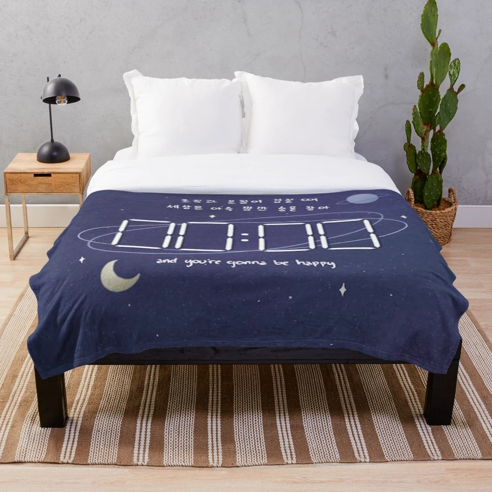 Celestial-inspired plush blanket with moon phase and sun and moon design