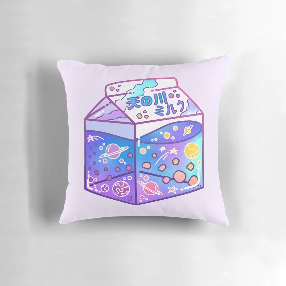 A colorful, glow-in-the-dark pillow featuring a Milky Way galaxy and milk carton design, perfect for creating a cozy, cosmic ambiance.