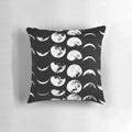 A black and white pillow with the phases of the moon design, perfect for adding a touch of celestial style to any space.