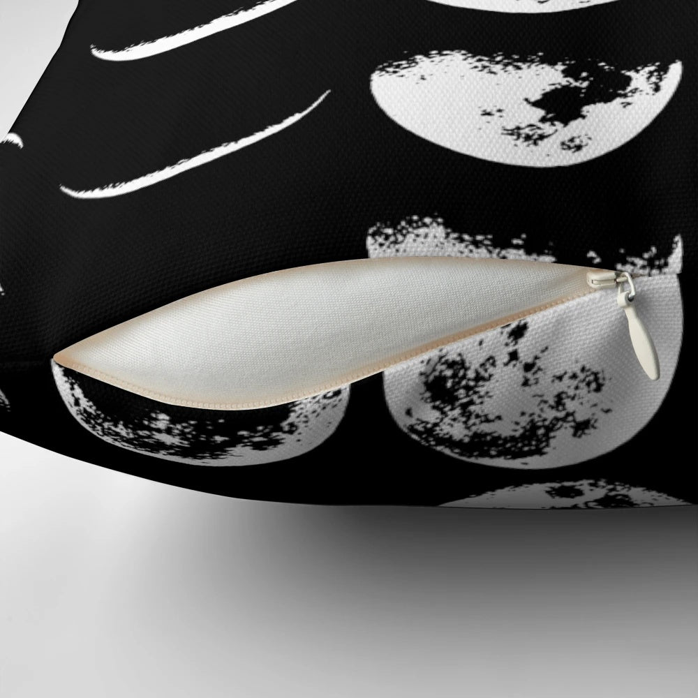 A black and white pillow with the phases of the moon design, perfect for adding a touch of celestial style to any space.
