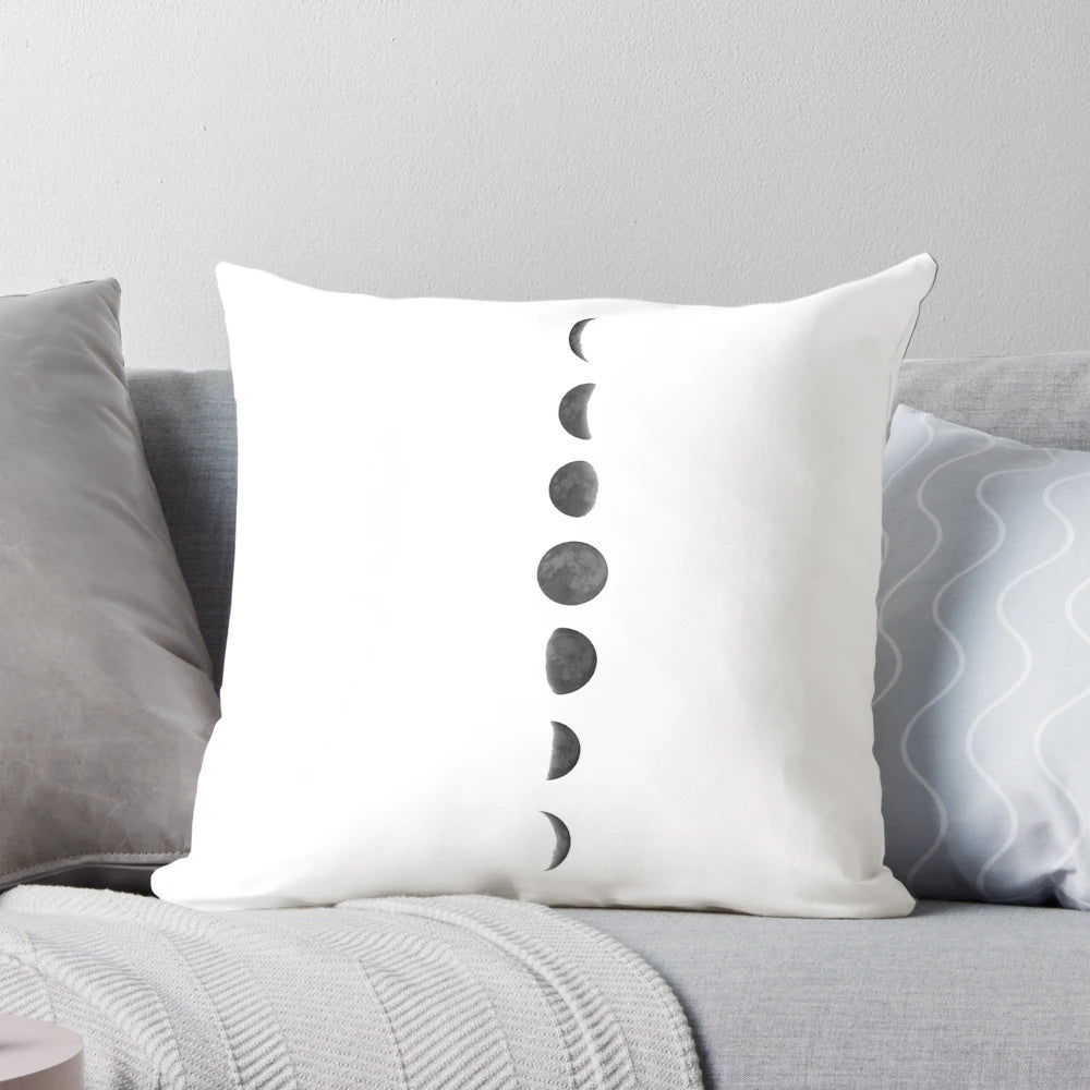 Soft, decorative pillow featuring phases of the moon and stars against a dark night sky background