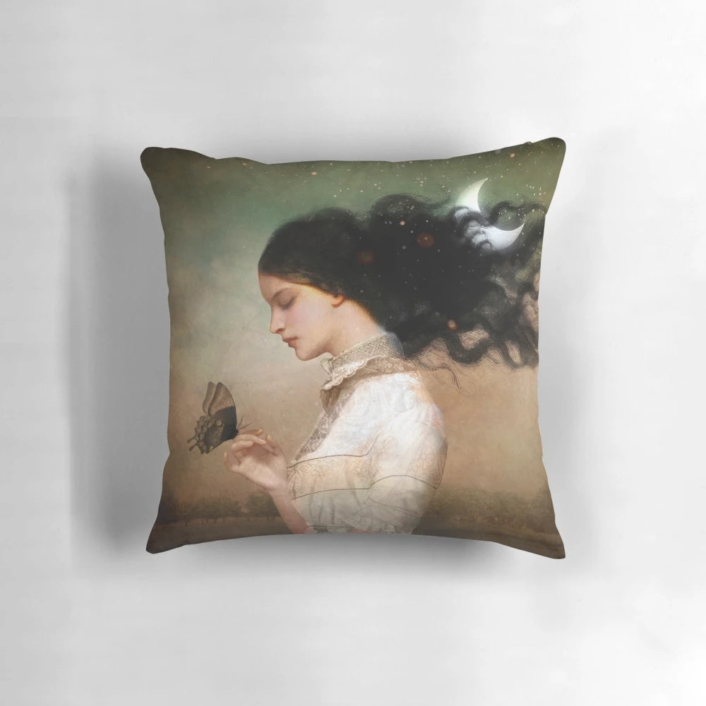 A cozy pillow featuring a night sky design with stars and a crescent moon
