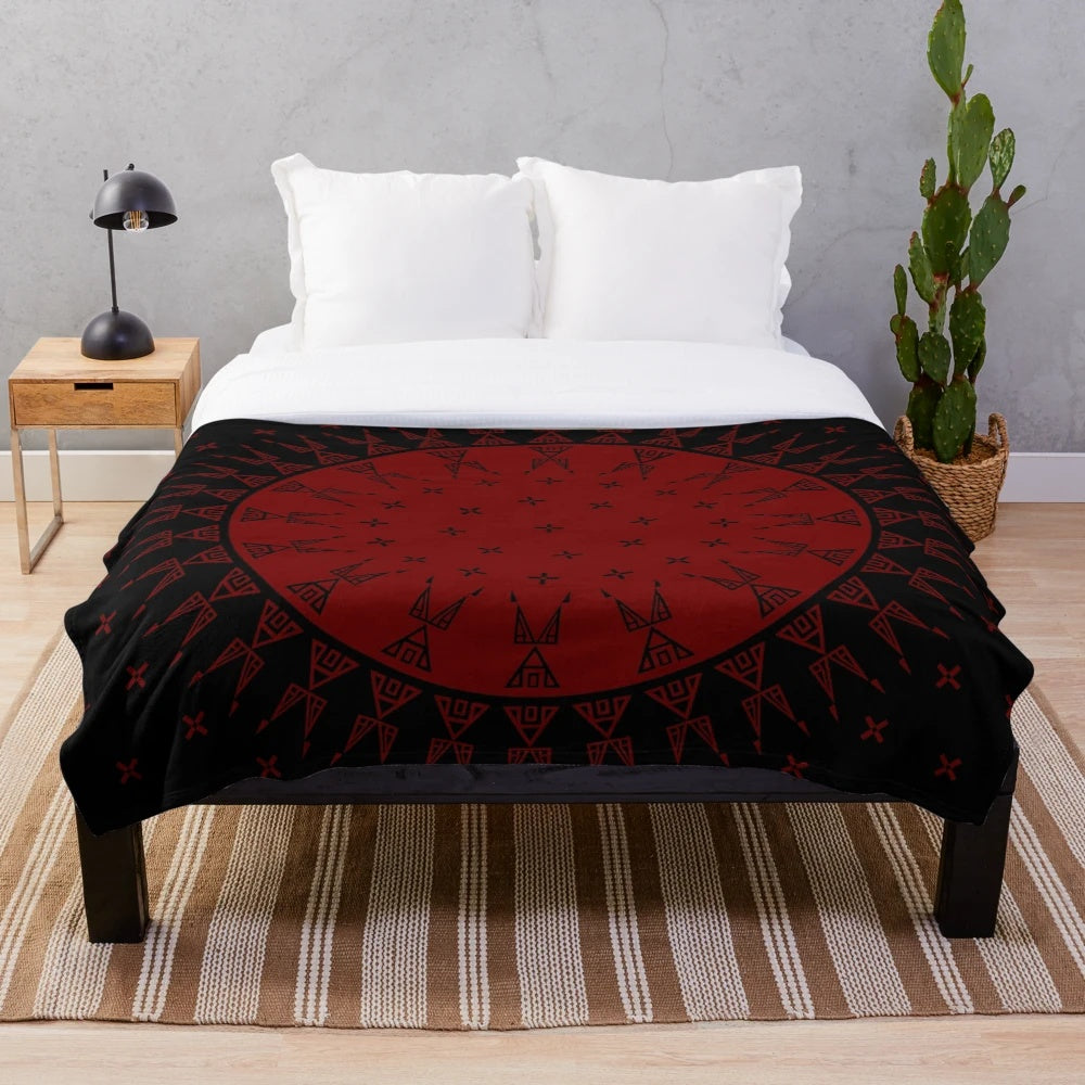 Maroon plush blanket with night sky and celestial motifs inspired by Native American art